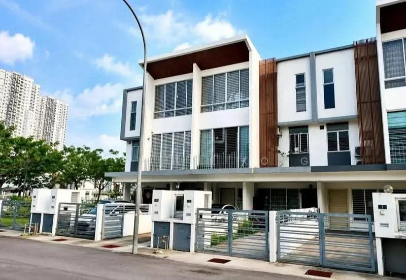 Exterior type: linked terrace house; features: white painted facade, wood paneling accents, large windows with horizontal slats, two-storey structure, manicured lawn in front, paved driveway, fenced front yard, surrounded by greenery, modern architectural design, clear blue sky, adjacent to high-rise buildings; style: modern.