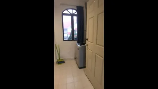 Room features: white painted walls, tiled flooring, arched window, black curtain, door with panel design, water dispenser, cleaning supplies, sweeping broom.