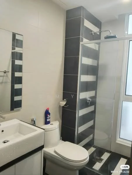 Bathroom features: white ceramic toilet, single-sink vanity with white cabinet, framed mirror, glass shower enclosure, rain shower head, handheld shower, black and white striped tile cladding, grey wall tiles, black floor tiles, window with sheer curtains, toilet cleaning bottle; style: modern.