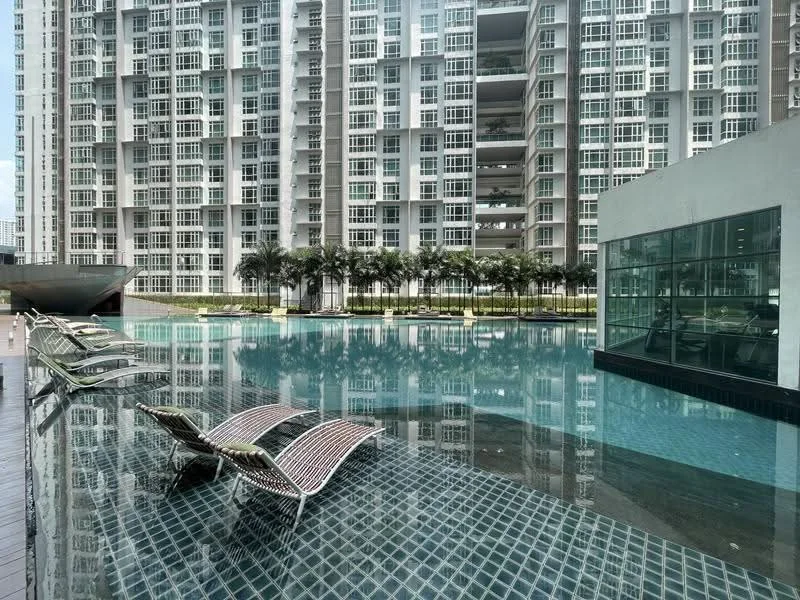 Exterior type: high-rise condominium; features: infinity pool, pool deck with loungers, glass curtain wall facade, surrounded by palm trees, manicured landscaping, multiple storeys, water feature, outdoor seating area; style: modern.