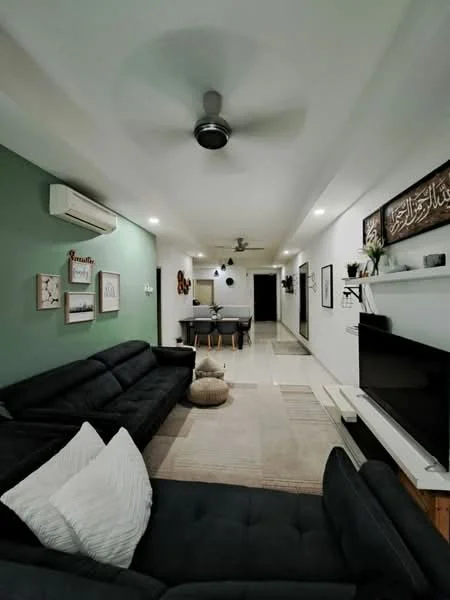 Living features: 3-seater fabric sofa in black, 2-seater fabric sofa in black, ceiling fan with light, wall-mounted TV, TV console in white, decorative wall art, green accent wall, marble tile flooring, recessed lighting, area rug with neutral color, air conditioning unit, decorative plants; style: modern. Room features: hallway leading to other rooms, dining area visible in background.
