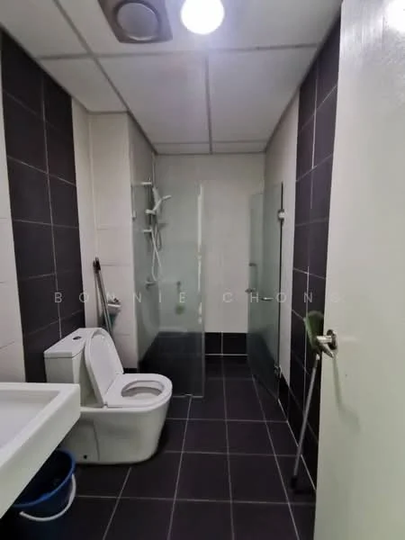 Bathroom features: white toilet, glass shower enclosure, chrome shower head, wall-mounted shower controls, single-sink vanity, white sink, black tiled flooring, dark grey tiled walls, ceiling light fixture, mirror above sink; style: modern.