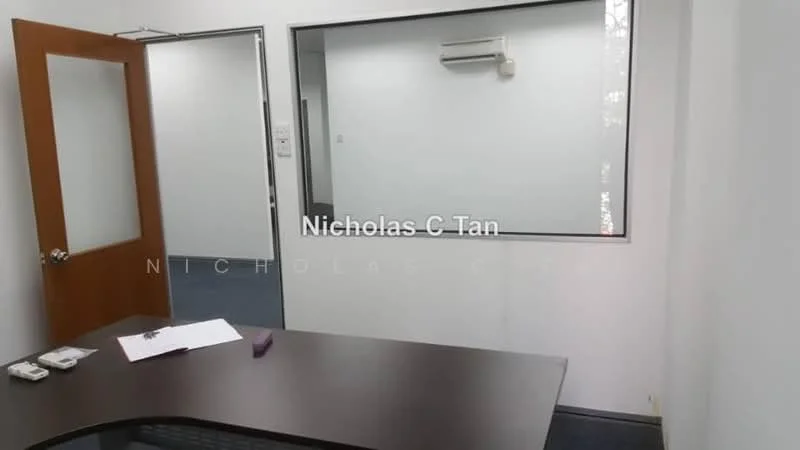Room features: white painted walls, carpet flooring, window with glass panel, wall-mounted split AC, wooden door, desk with dark surface, paper on desk, pen on desk; style: modern.