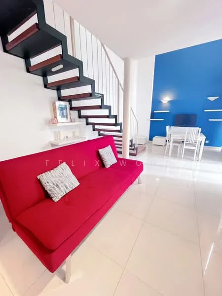 Living features: red fabric sofa, 2 decorative cushions, white wall, blue accent wall, white tiled flooring, staircase with black railing, white shelves, dining table with chairs, recessed wall lighting; style: modern.
