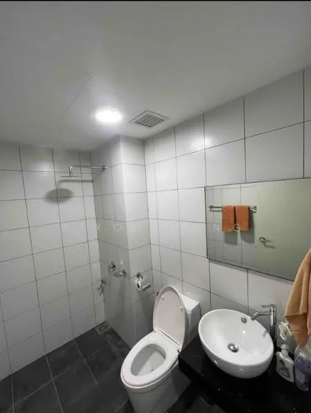 Bathroom features: white tiled walls, grey tiled flooring, one-piece toilet, single-sink vanity with black countertop, round ceramic sink, chrome basin mixer faucet, framed mirror, shower head, towel rack, orange hand towels; style: modern.