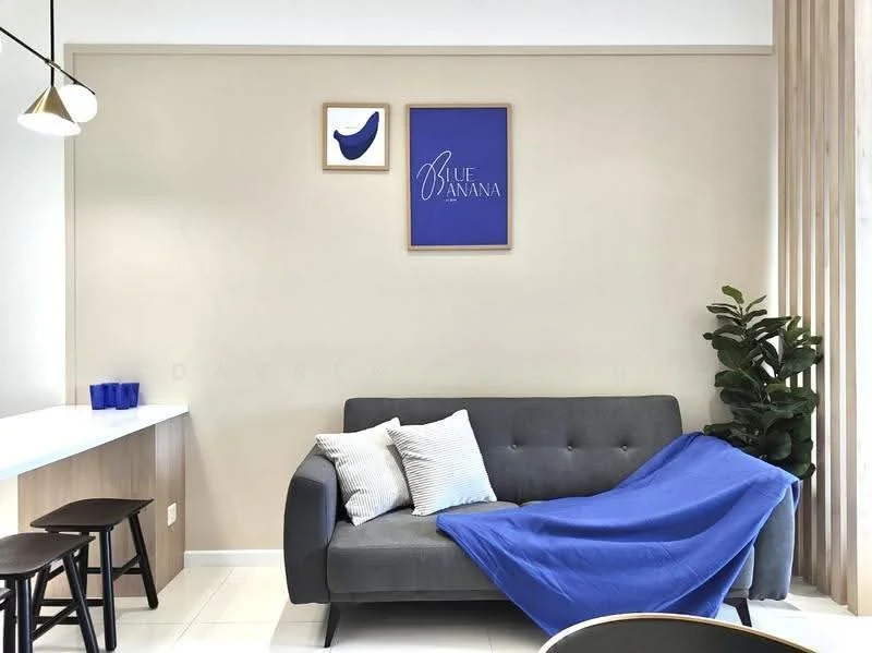 Living features: grey fabric sofa, blue throw blanket, two decorative cushions, framed artwork on wall, light beige painted walls, white ceiling, wooden bar counter, three wooden bar stools, indoor plant, white floor tiles, pendant light fixture; style: modern.