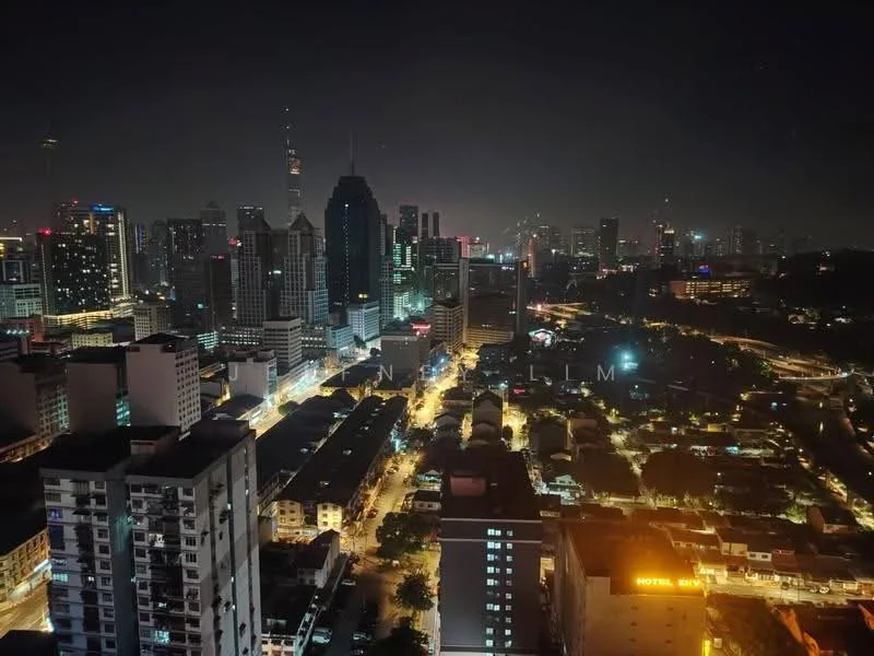 Exterior type: high-rise condominium; features: city skyline view, nighttime lighting, urban landscape, high-rise buildings, streetlights, traffic on roads, surrounding greenery; style: modern.