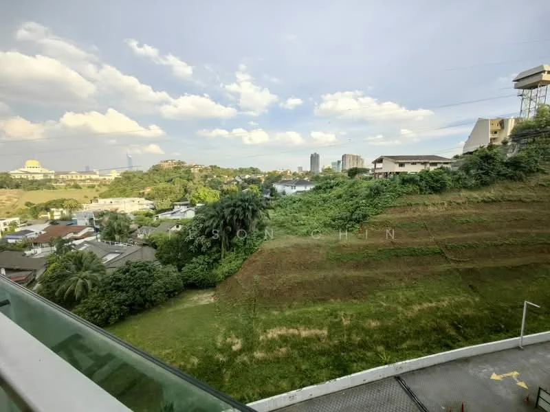 Exterior features: green hillside, urban skyline in background, mature trees, manicured lawn, clear blue sky, scattered clouds, residential buildings visible, paved driveway.