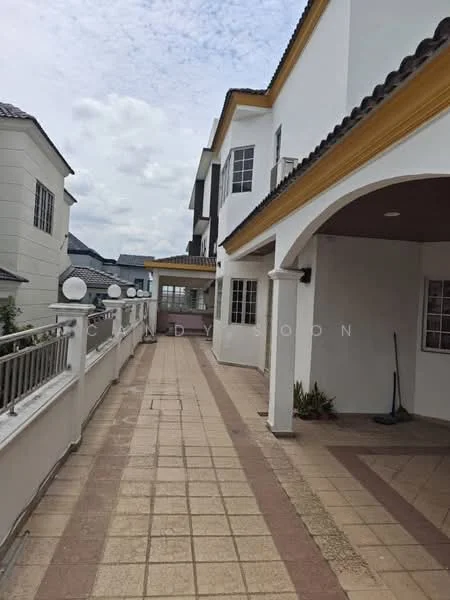 Exterior type: detached bungalow; features: paved walkway, white painted facade, yellow decorative trim, multiple windows, gabled roof, balcony, outdoor lighting fixtures, landscaped area with plants, surrounding residential buildings; style: modern.