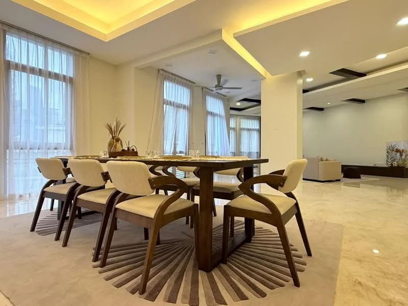 Dining features: 6-seater dining table, wooden dining table, upholstered dining chairs, area rug with circular pattern, floor-to-ceiling windows, sheer curtains, marble flooring, ceiling fan with light, recessed lighting, neutral wall color; style: modern. Room features: open layout, high ceiling, natural light.