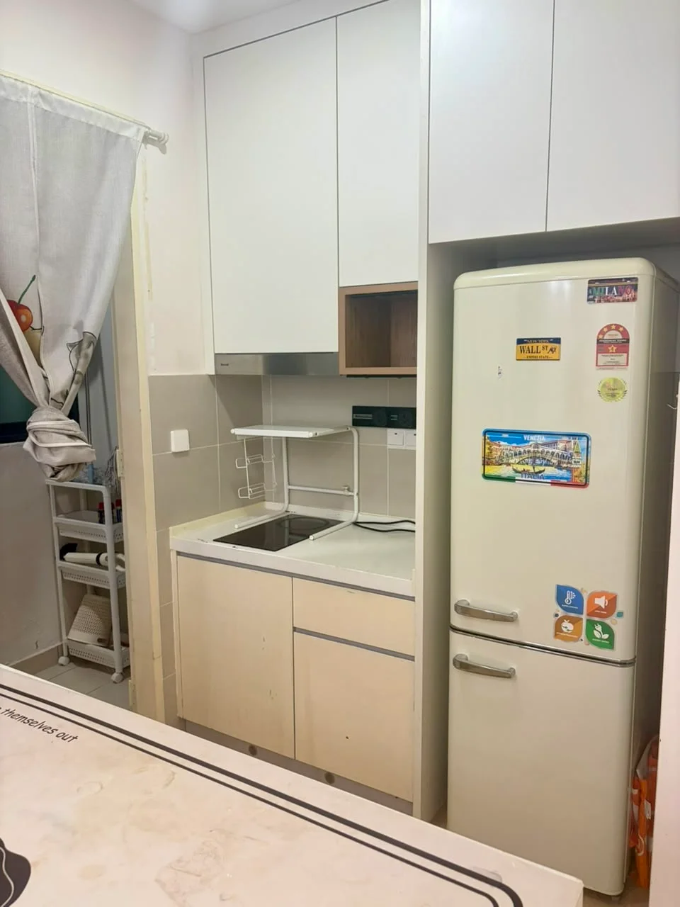 Kitchen features: white cabinetry, wood accent cabinetry, marble countertop, built-in cooktop, stainless-steel sink, chrome faucet, refrigerator with stickers, open shelving, window with curtain; style: modern.