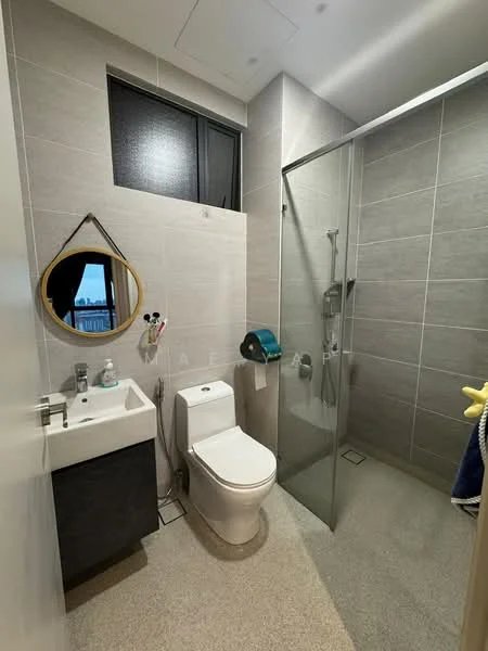 Bathroom features: grey tiled walls, light grey floor tiles, single-sink vanity with dark cabinet, round mirror, one-piece toilet, walk-in shower with glass enclosure, chrome shower head, handheld shower, towel holder, toilet paper holder, window for natural light; style: modern; view: city.