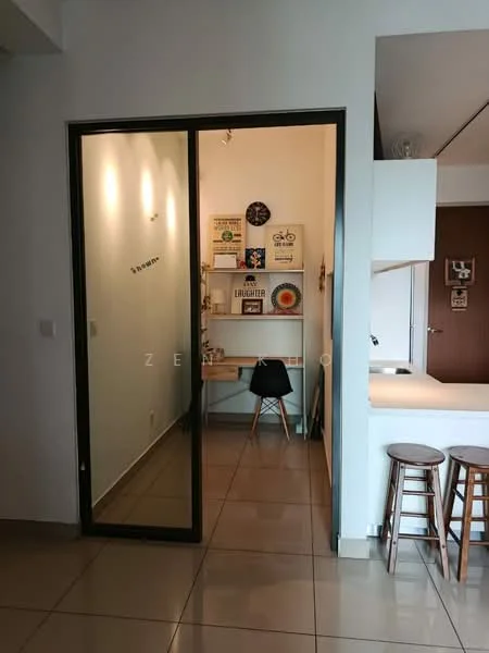 Room features: glass sliding door, white walls, tile flooring, wooden desk, black chair, decorative wall art, light fixtures on wall, open kitchen area visible; style: modern.
