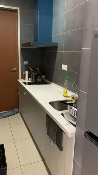 Kitchen features: grey tiled walls, white countertop, stainless-steel double-bowl sink, chrome pull-down faucet, blue kitchen hood, built-in cabinetry, ceramic tile flooring, refrigerator, kitchen utensils on countertop, paper towel holder, dish rack, bottle of cooking oil; style: modern.