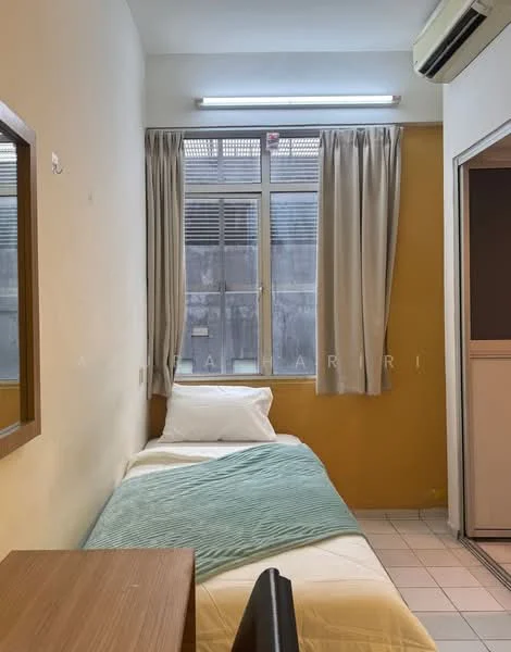 Bedroom features: single bed with white bedding, green throw blanket, wooden bedside table, mirror on wall, floor-to-ceiling window, sheer curtains, yellow accent wall, white painted walls, tile flooring, wall-mounted air conditioning unit, LED ceiling light; style: minimalist.
