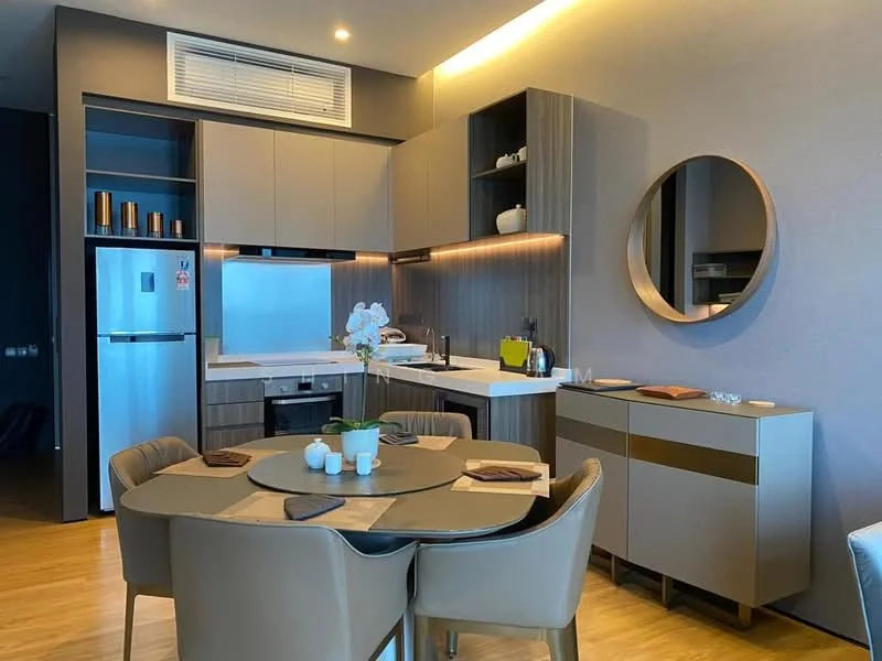 Kitchen features: grey cabinetry, white countertop, stainless-steel fridge, built-in oven, 4-burner gas hob, single-bowl stainless-steel sink, chrome pull-down faucet, wall-mounted microwave, round dining table, upholstered dining chairs, decorative mirror, recessed downlights, wooden flooring; style: modern.