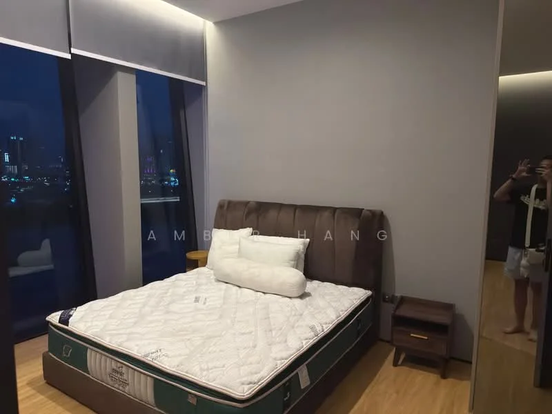 Bedroom features: king-size bed, upholstered headboard, wooden bedside table, floor-to-ceiling windows, city skyline view, laminate flooring, grey painted walls, decorative mirror; style: modern; view: city.