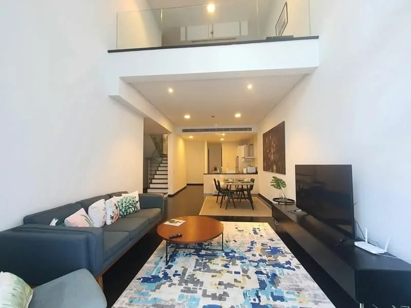 Living features: 3-seater fabric sofa in grey, coffee table, wall-mounted TV, area rug with abstract pattern, recessed LED downlights, high ceiling, open-plan layout, large windows, wooden flooring; style: modern. Dining features: dining table for 4, upholstered dining chairs, open kitchen layout; style: modern.