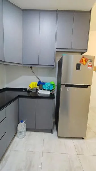 Kitchen features: grey flat-panel cabinets, black countertop, stainless-steel fridge, white ceramic tile flooring, water bottle on floor, colorful dish drying rack, wall-mounted electrical outlet, under-cabinet lighting; style: modern.