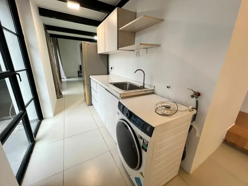 Kitchen features: white cabinetry, stainless-steel sink, chrome faucet, built-in washing machine, refrigerator, open shelving, grey tiled backsplash, white tiled flooring, black exposed beams, large windows, natural light, countertop space; style: modern.