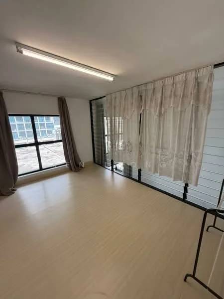 Room features: large window with black frame, sheer curtains, plain white walls, light-colored flooring, fluorescent ceiling lights, open space layout, minimalist decor; style: modern; view: city.