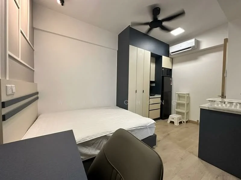 Bedroom features: queen-size bed, light wood flooring, white painted walls, ceiling fan, built-in wardrobe with sliding doors, black refrigerator, built-in kitchen cabinet, white countertop, small white stool, air conditioning unit, study desk, task chair; style: modern.