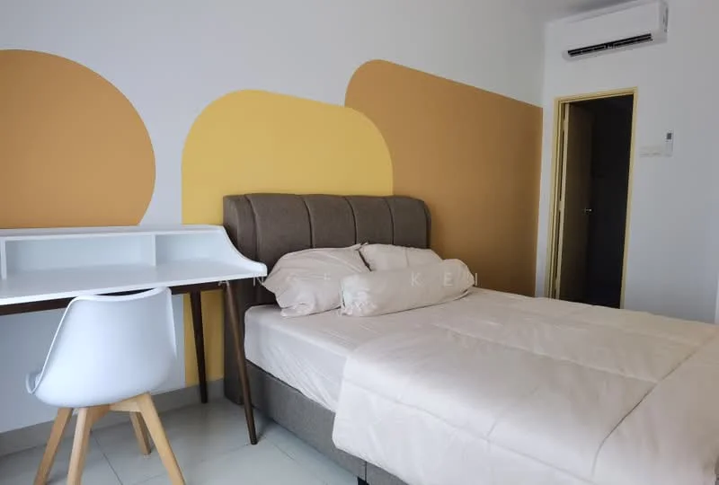 Bedroom features: queen-size bed with upholstered headboard, light beige bedding, study desk with white surface, white chair with wooden legs, air conditioning unit on wall, painted accent wall in yellow and brown, light-colored floor tiles, built-in wardrobe with door; style: modern.