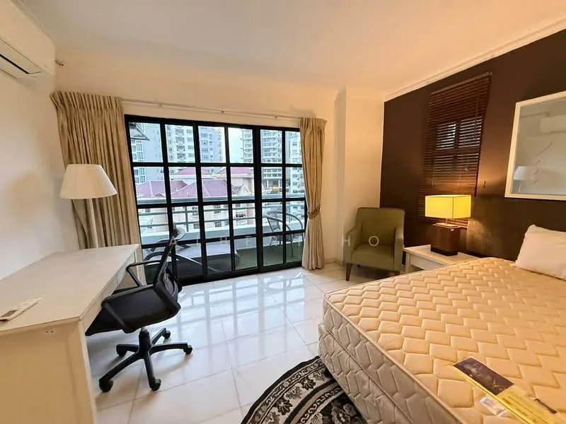 Bedroom features: queen-size bed with beige mattress, white bedding, wooden headboard, desk with white finish, black office chair, floor-to-ceiling windows, sheer curtains, dark brown accent wall, light-colored tiled flooring, table lamp with yellow shade, green accent chair, decorative area rug with geometric pattern, air conditioning unit; style: modern; view: city.
