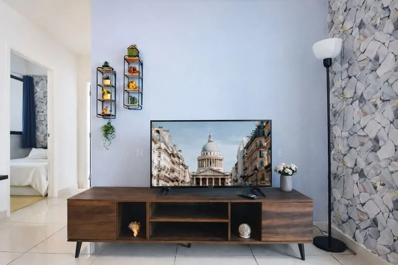 Living features: light grey painted walls, stone accent wall, white floor tiles, wooden TV console, wall-mounted TV, decorative shelving unit with plants and decor, floor lamp, decorative items on console; style: modern.