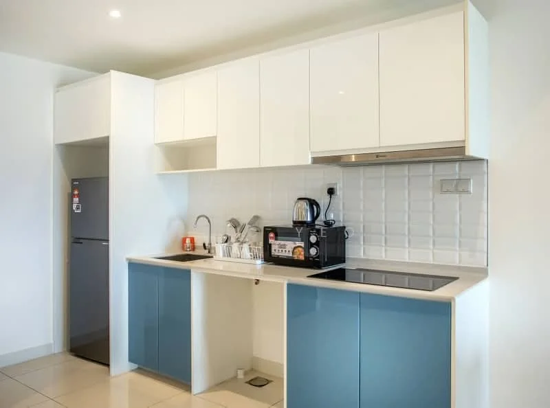 Kitchen features: white upper cabinets, blue lower cabinets, stainless-steel sink, chrome pull-down faucet, built-in electric cooktop, built-in oven, black countertop, white tile backsplash, stainless-steel refrigerator, coffee machine, dish rack, kitchen utensils, recessed downlights, wall-mounted power outlets; style: modern.