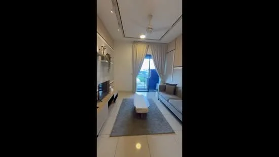 Living features: light-colored walls, recessed downlights, 5-blade ceiling fan, floor-to-ceiling windows, sliding glass door, curtains, grey area rug, light wood coffee table, sofa with cushions, TV console, wall-mounted TV; style: modern; view: city.