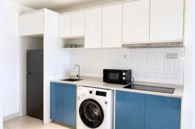 Kitchen features: white upper cabinets, blue lower cabinets, stainless-steel sink, chrome faucet, built-in electric stove, microwave, freestanding washing machine, stainless-steel fridge, white tiled backsplash, countertop with light-colored surface, open shelving above cabinets, tile flooring; style: modern.