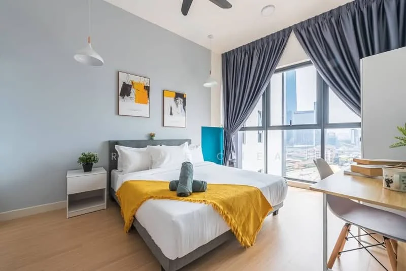 Bedroom features: king-size bed with white bedding, yellow throw blanket, upholstered headboard, 2 bedside lamps, nightstand with plant, large windows with city view, floor-to-ceiling curtains, wooden flooring, study desk with chair, wall-mounted artwork, ceiling fan; style: modern; view: city.