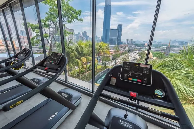 Room features: treadmills, large floor-to-ceiling windows, city skyline view, greenery outside, modern fitness equipment, concrete flooring, natural light, potted plants; style: modern; view: city.