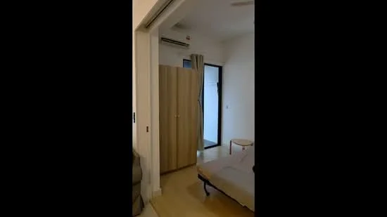 Room features: light wood flooring, white painted walls, ceiling fan, wall-mounted split AC, door with wood finish, curtains, single bed, small side table; style: modern.