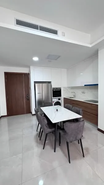 Dining features: white marble dining table, 4 upholstered dining chairs in grey, refrigerator, built-in oven, stainless-steel range hood, kitchen cabinetry in wood finish, white quartz countertop, ceramic tile flooring, recessed ceiling lights, wall-mounted air conditioning unit, door leading to hallway; style: modern.