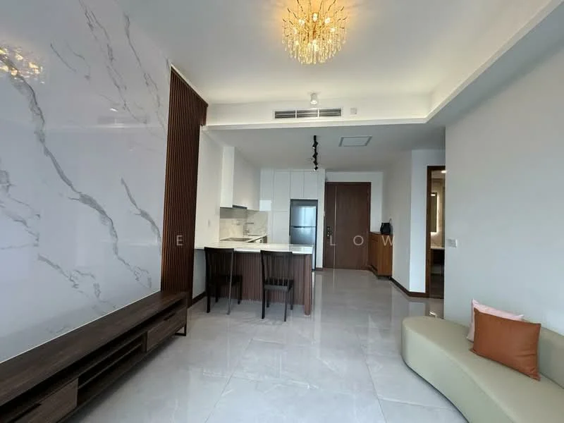 Living features: white marble accent wall, light grey painted walls, polished marble flooring, chandelier with multiple bulbs, built-in kitchen with white cabinetry, kitchen island with seating, dark wood TV console, large windows for natural light, neutral-toned sofa, decorative cushion, wooden door, recessed ceiling lights; style: modern.
