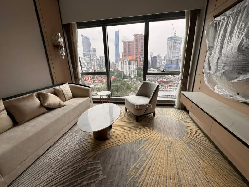Living features: floor-to-ceiling windows, beige fabric sofa, coffee table with round glass top, area rug with geometric pattern, decorative wall paneling, wall-mounted TV console, upholstered armchair, city skyline view; style: modern; view: city.