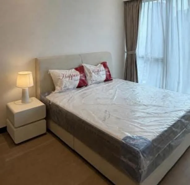 Bedroom features: king-size bed, upholstered headboard, two decorative pillows with text, bedside lamp, nightstand with drawer, floor-to-ceiling window, sheer curtains, wooden flooring, light-colored walls; style: modern.