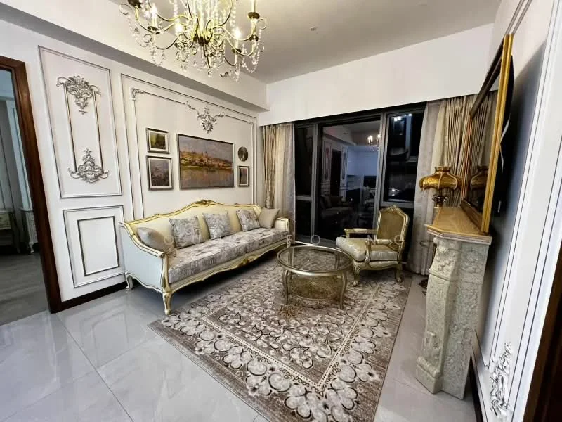 Living features: chandelier, 3-seater upholstered sofa with ornate detailing, armchair with gold accents, glass coffee table, decorative area rug with intricate pattern, wall-mounted TV, framed artwork on walls, curtains, wall paneling with decorative moldings, marble flooring; style: luxury.