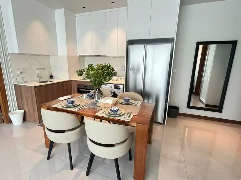 Kitchen features: white cabinetry, marble backsplash, stainless-steel fridge, built-in oven, 4-burner gas hob, single-bowl stainless-steel sink, chrome pull-down faucet, dining table with wooden top, 4 upholstered dining chairs, table setting with plates and cutlery, potted plant, grey tile flooring, recessed downlights; style: modern.