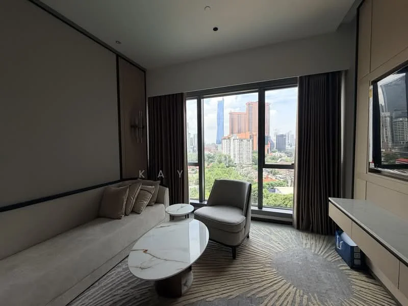 Living features: floor-to-ceiling windows, city view, light grey fabric sofa, marble coffee table, beige upholstered armchair, TV console, wall-mounted TV, decorative wall paneling, curtains, area rug with geometric pattern; style: modern.