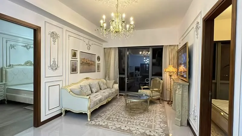 Living features: chandelier, sofa with ornate detailing in cream and gold, glass coffee table, area rug with floral pattern, wall-mounted artwork, decorative wall paneling, curtains in light fabric, side lamp with decorative shade, floor-to-ceiling windows, polished tile flooring, crown moulding on ceiling; style: luxury; view: city.