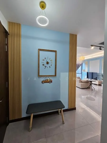Room features: blue painted walls, wood paneling, framed wall clock, black bench, glossy tile flooring, ceiling light fixture with circular design, decorative artwork, open layout leading to living area; style: modern.