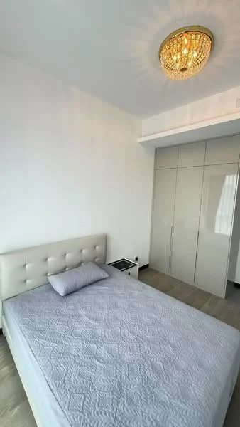 Bedroom features: queen-size bed with upholstered headboard, light grey bedding, white painted walls, light wood flooring, built-in wardrobe with sliding doors, chandelier light fixture, nightstand with drawer, window with sheer curtains; style: modern.