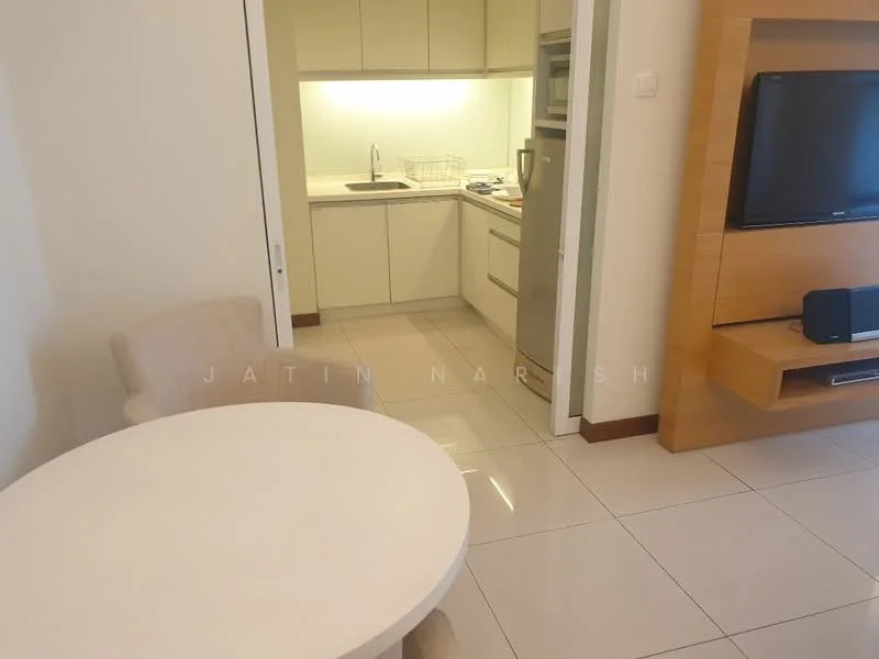 Living features: round dining table, upholstered dining chairs, wall-mounted TV, TV console, light-colored walls, glossy tile flooring, recessed lighting, open-plan layout, neutral decor; style: modern. Kitchen features: single-bowl stainless-steel sink, chrome pull-down faucet, built-in oven, freestanding range oven, microwave, white cabinetry, countertop with storage, ceramic tile backsplash; style: modern.