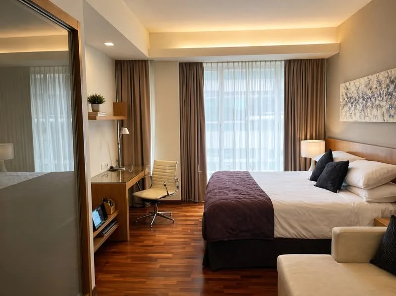 Bedroom features: queen-size bed with white bedding, upholstered headboard, two black decorative pillows, wooden flooring, large window with sheer curtains, desk with lamp and chair, wall-mounted artwork, built-in wardrobe, recessed ceiling lighting, plant in ceramic pot, side table with lamp; style: modern.