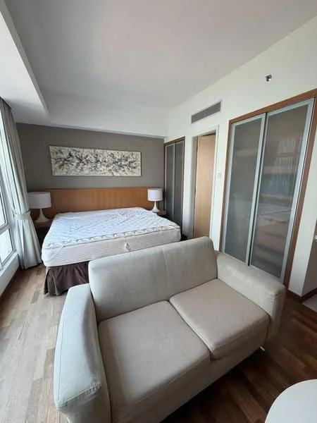 Bedroom features: queen-size bed with white bedding, wooden headboard, two bedside lamps, floor-to-ceiling windows, light brown wooden flooring, built-in wardrobe with glass doors, artwork on wall, neutral wall color; style: modern; view: city.