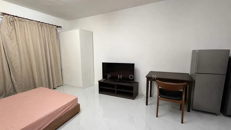 Bedroom features: queen-size bed with pink bedspread, white walls, white tiled flooring, curtains in beige, built-in wardrobe with sliding doors, wall-mounted TV, TV console, wooden study desk, wooden chair, stainless-steel fridge; style: minimalist.