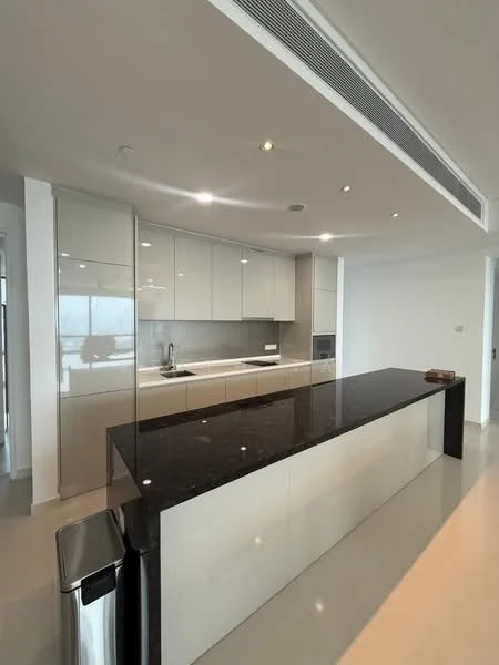 Kitchen features: black granite countertop, white glossy cabinetry, stainless-steel sink, chrome pull-down faucet, built-in oven, microwave, recessed downlights, sliding glass door, open layout, tile flooring, kitchen island, pantry, modern appliances, minimalist design; style: modern; view: city.
